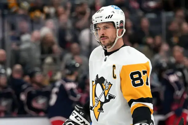 COLUMBUS, OHIO - APRIL 13: Sidney Crosby #87 of the Pittsburgh Penguins looks on during a stoppage of play in the second period against the Columbus Blue Jackets at Nationwide Arena on April 13, 2023 in Columbus, Ohio. We hate Sid the Kid because he is skilled and a poor sport. He also couldn't grow a proper beard apparently. 