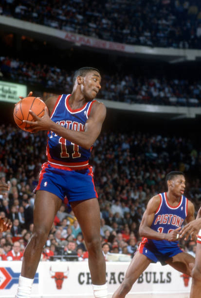 CHICAGO, IL - CIRCA 1990: Isiah Thomas #11 of the Detroit Pistons grabs a rebound against the Chicago Bulls during an NBA basketball game circa 1990 at Chicago Stadium in Chicago, Illinois. Thomas played for the Pistons from 1981-94. (Photo by Focus on Sport/Getty Images)