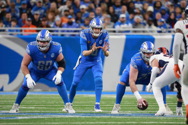 Detroit Lions quarterback Jared Goff (16) waits for the snap from center Frank Ragnow (77) during the first half of an NFL football game between the Denver Broncos and the Detroit Lions in Detroit, Michigan USA, on Saturday, December 16, 2023. (Photo by Jorge Lemus/NurPhoto via Getty Images)
