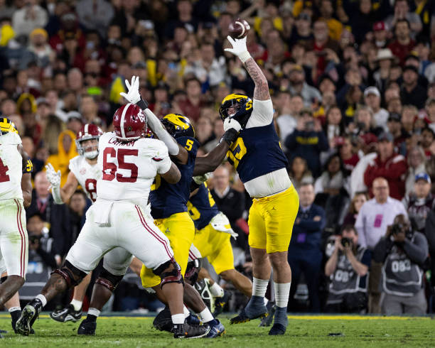 PASADENA, CA - JANUARY 1: Mason Graham #55 of the Michigan Wolverines deflects a pass from Jalen Milroe #4 of the Alabama Crimson Tide during the Rose Bowl between University of Alabama and University of Michigan at the Rose Bowl on January 1, 2024 in Pasadena, California. (Photo by Steve Limentani/ISI Photos/Getty Images)