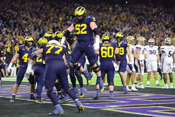 HOUSTON, TEXAS - JANUARY 08: Blake Corum #2 of the Michigan Wolverines celebrates with teammates after scoring a touchdown in the fourth quarter against the Washington Huskies during the 2024 CFP National Championship game at NRG Stadium on January 08, 2024 in Houston, Texas. (Photo by Stacy Revere/Getty Images)