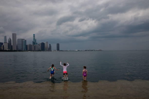 Kids take dip in Lake Michigan as thunderstorm clouds approach Chicago on Aug. 10, 2020. (Zbigniew Bzdak/Chicago Tribune/Tribune News Service via Getty Images)